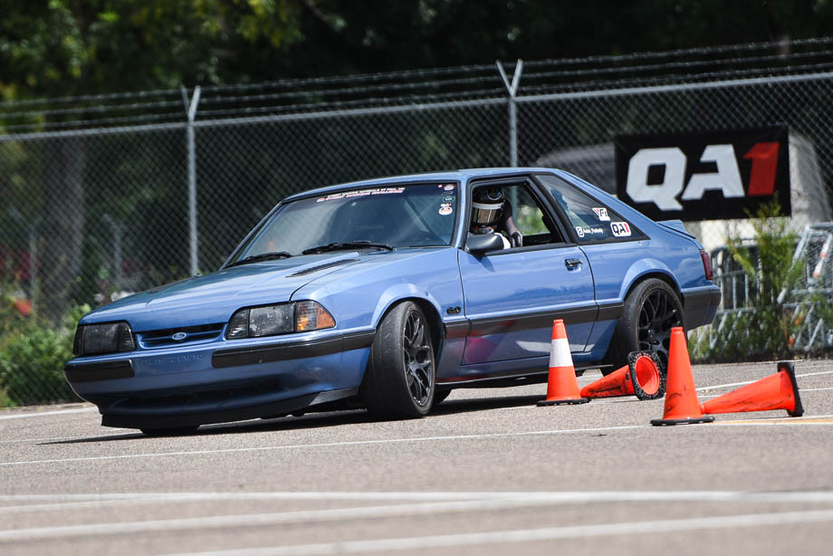 Fox body Mustang on QA1 shocks rounding a corner on the track. Fox body Mustang on QA1 shocks rounding a corner on the track.